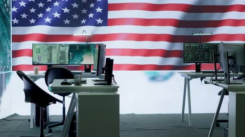 Empty Office with Computers and American Flag Backdrop