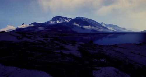 Mountain Landscape Under a Twilight Sky with Clouds Over a Serene Lake