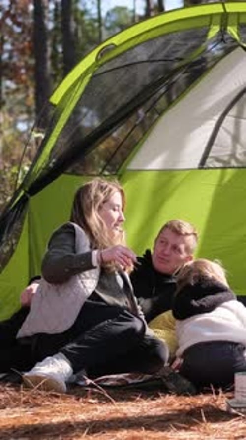 Vertical Video Family Relaxing in a Tent in the Forest Laughing and Exploring Nature
