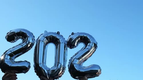 Silver Foil Number 2023 Change to 2024 Celebration New Year Balloon on Blue Sky Background Happy New