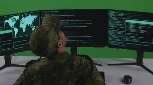 Asian Man Soldier Having Backache While Write Code With Multiple Computer Screens In Green Screen