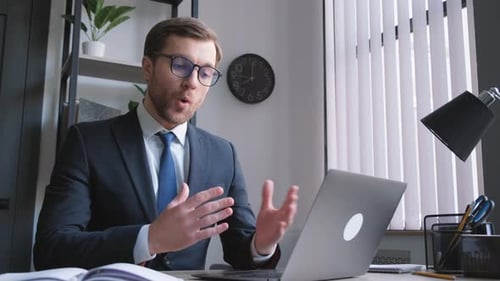 Man in Suit Having Video Call on Laptop