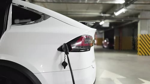 Electric Car Being Charged in Underground Parking Garage