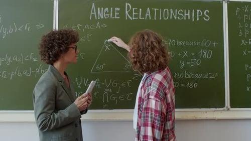 Teacher and Teen Studying Angle Relationships in Classroom