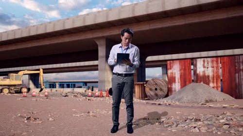 Asian Male Use Tablet And Headache At Building Site