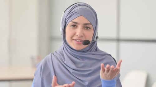Muslim Woman in Hijab with Headset Talking with Customers in Call Center