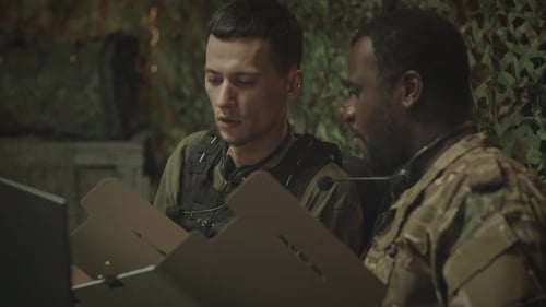 Soldiers Reviewing Documents in a Bunker