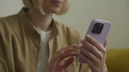 Woman Using Smartphone with Lilac Case Indoors