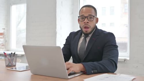 Denying Mixed Race Businessman Rejecting while Using Laptop in Office