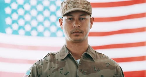 Soldier in Camouflage Uniform Saluting American Flag