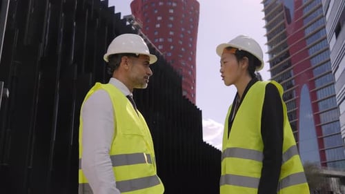Construction Professionals Discussing Project and Shaking Hands