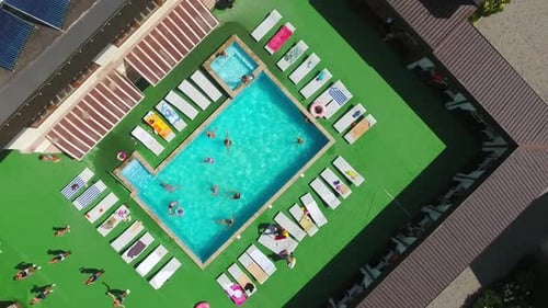 Vacational outdoor swimming pool. Holiday resort summer pool aerial view.