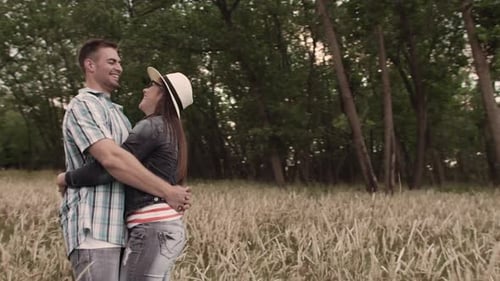 Romantic and In-Love Couple Holding Each Other in Grass Field