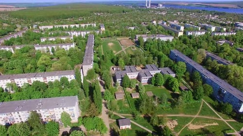 Sunny city drowning in the greenery. Drone footage of Ukrainian city on fantastic sunny day.