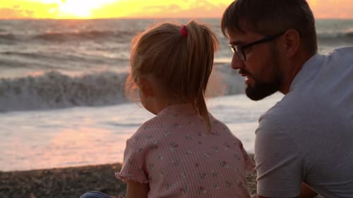 Family Father and Child Sit By Ocean and Look at and Sunset Travel and Vacation