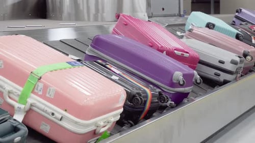 Colorful Luggage on Airport Conveyor Belt