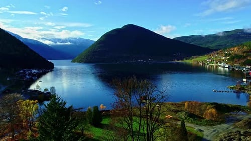 Aerial view over a beautiful colorful landscape overlooking the valley with blue lake and majestic m