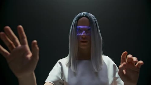 Woman Using Augmented Reality Glasses in Dark Room