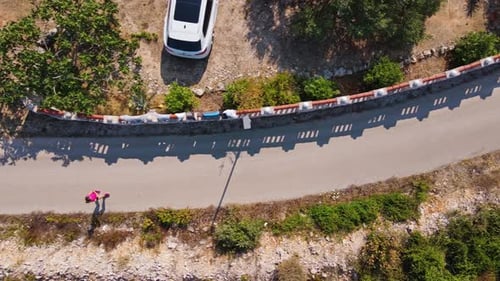 Top View of Woman Jogging on Country Road