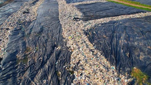 4K : Aerial view from a drone flying over a large pile of garbage