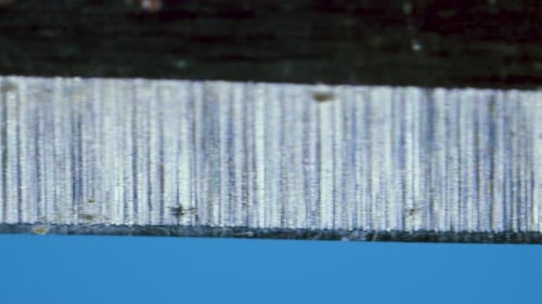 Extreme Close Up of a Sharp Blade on Blue