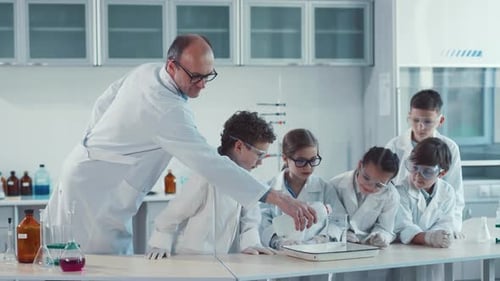Children Conduct Science Experiment with Teacher in Lab