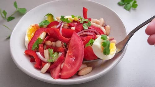 Colorful Garden Salad Being Served from White Bowl