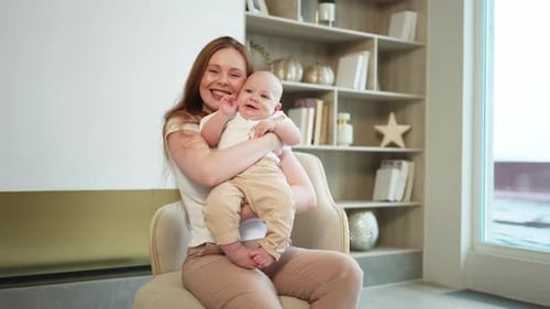 Loving Mother Cuddles Her Adorable Baby
