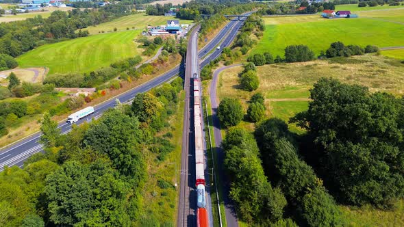 Freight Train Traveling Beside Busy Highway Through Countryside ...