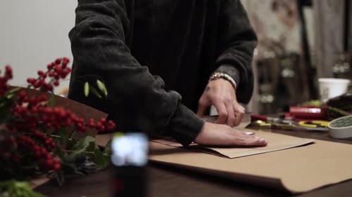 Crafting Artisan Cuts Paper on Wooden Table