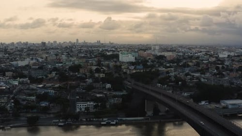 AERIAL - Bridge at dusk in Santo Domingo, Dominican Republic, wide shot forward