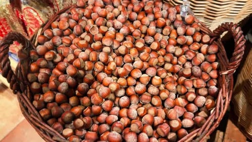 Abundant Hazelnuts Filling a Woven Basket, Brown Food