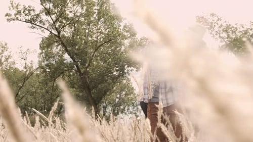 Young caucasian couple piggybacking and laughing in a sunny field together