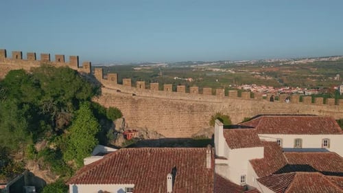 Stone Castle Walls Surrounding Historic Town on Beautiful Green Hills Drone View