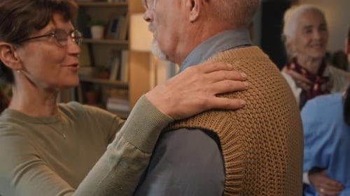 Close-up of Elderly Woman Slowdancing with Senior Man in Retirement Home