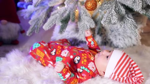 Cute Infant Celebrates Christmas Holiday Under Decorated Tree