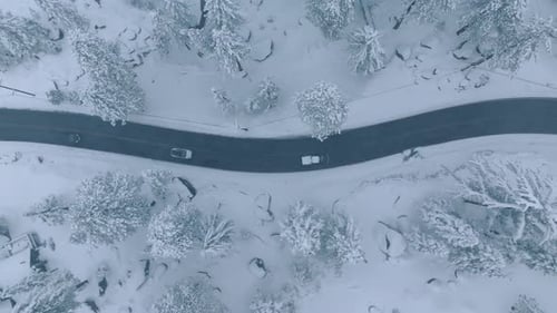 Enjoy the Breathtaking Beauty of a Snowcovered Road in Superb Resolution