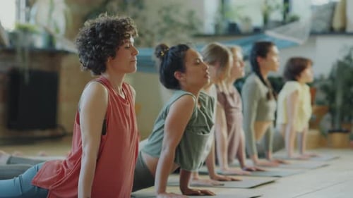 Women Doing Yoga in Bright Studio, Cobra Pose
