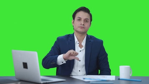 Disappointed Indian businessman showing thumbs down Green screen
