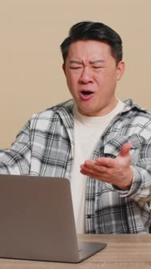 Man Using Laptop Reacting Emotionally