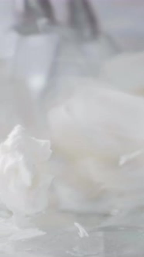 Soft White Cream Texture with Delicate Swirls and Smooth Surface for Culinary or Beauty Applications