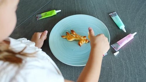 Child Decorating Star Shaped Cookie with Frosting