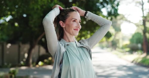 Woman Tying Her Hair Back Before a Run