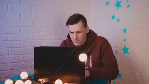Young Adult Working on a Laptop Computer at Home