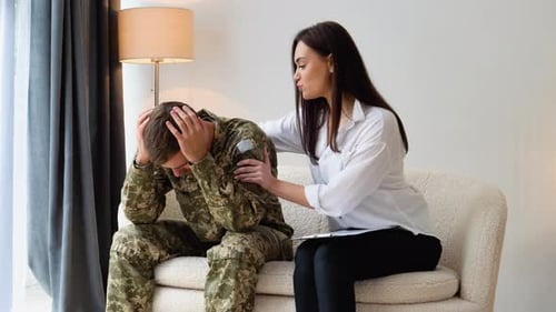 Counselor Supporting Upset Soldier in Office