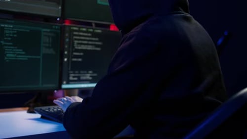 Close Up of Hacker Running Code in Apartment on PC Monitors