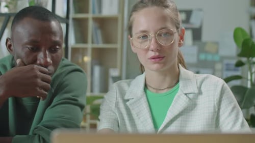 Young Diverse Man and Woman Working Together in Office