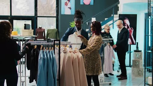 Couple Shopping for Clothes in Fashionable Boutique