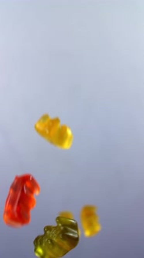 Gummy Bears Falling Against White Background