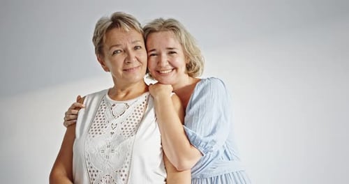 Two Smiling Women Embracing in Studio
